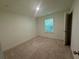 Neutral bedroom features a window and ample space for customization at 7695 Baron Rd, Fairburn, GA 30213