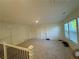 Bright bonus room with neutral carpet, white walls, and a window with wooden blinds at 7695 Baron Rd, Fairburn, GA 30213