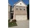 Charming home featuring a brick facade, attached garage, and well-maintained landscaping at 7695 Baron Rd, Fairburn, GA 30213