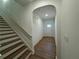 Hallway with stairs and an archway that leads to the front door at 7695 Baron Rd, Fairburn, GA 30213