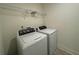 Laundry room featuring a washing machine and a dryer, along with wire shelving at 7695 Baron Rd, Fairburn, GA 30213