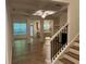 Open-concept living space with modern finishes, hardwood floors, and lots of natural light at 7695 Baron Rd, Fairburn, GA 30213
