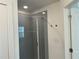 Modern bathroom features a glass-enclosed shower with sleek fixtures and gray tiling at 7695 Baron Rd, Fairburn, GA 30213