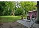 Backyard with lush greenery, patio with hammock, and mature trees at 842 Third St, Stone Mountain, GA 30083