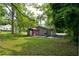 Spacious backyard with a shed, patio, and mature trees at 842 Third St, Stone Mountain, GA 30083