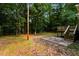 A spacious backyard with a wooden deck and patio amid mature trees at 10149 Puckett Sw St, Covington, GA 30014