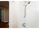 Tiled shower/tub combo with sleek fixtures at 10149 Puckett Sw St, Covington, GA 30014