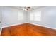 Bright bedroom features hardwood floors, natural lighting and neutral color palette at 10149 Puckett Sw St, Covington, GA 30014
