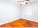 Simple bedroom features hardwood floors, ceiling fan, and a single window with natural light at 10149 Puckett Sw St, Covington, GA 30014