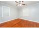 Well-lit bedroom with hardwood floors, neutral walls, and a ceiling fan at 10149 Puckett Sw St, Covington, GA 30014