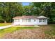 Charming one-story home with light gray brick, green shutters, and a well-manicured lawn at 10149 Puckett Sw St, Covington, GA 30014