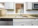 Close up of modern kitchen featuring granite countertops, gray cabinets, and stainless steel appliances at 10149 Puckett Sw St, Covington, GA 30014