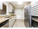 Modern kitchen with stainless steel appliances, light gray cabinets, and granite countertops at 10149 Puckett Sw St, Covington, GA 30014