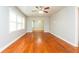 Spacious living room with hardwood floors, large windows, and neutral walls at 10149 Puckett Sw St, Covington, GA 30014