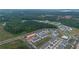 Aerial shot of a new townhome community featuring a pool, cabana, and community green spaces at 124 Saginaw Ct, Locust Grove, GA 30248