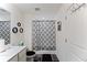 Stylish bathroom features a shower with black-and-white patterned curtain, and white fixtures, and modern decor at 124 Saginaw Ct, Locust Grove, GA 30248