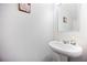 Half-bathroom featuring a sleek, modern vessel sink, clean white walls, and minimalist decor at 124 Saginaw Ct, Locust Grove, GA 30248