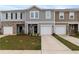 Charming townhomes featuring individual garages, landscaped lawns, and inviting front entrances at 124 Saginaw Ct, Locust Grove, GA 30248