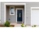 Close-up of an inviting front door with decorative details and a well-lit porch area at 124 Saginaw Ct, Locust Grove, GA 30248