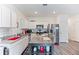 Bright kitchen features white cabinets, stainless steel appliances, and center island with a grey countertop at 124 Saginaw Ct, Locust Grove, GA 30248