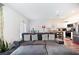 Open-concept living area with a comfortable couch that flows into a modern kitchen and dining area at 124 Saginaw Ct, Locust Grove, GA 30248