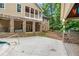 A spacious backyard features a stone patio, outdoor kitchen, and lush greenery for relaxation and entertaining at 561 Holland Rd, Dallas, GA 30157