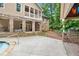 Backyard view of the pool, outdoor pavilion, stone accents, and lush landscaping at 561 Holland Rd, Dallas, GA 30157