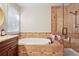 Stylish bathroom showcasing a soaking tub, glass-enclosed shower, and modern fixtures at 561 Holland Rd, Dallas, GA 30157