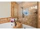 Luxurious bathroom featuring a glass-enclosed shower, separate soaking tub, and beautiful tile work at 561 Holland Rd, Dallas, GA 30157