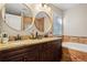 Elegant bathroom with double vanity, granite countertops, soaking tub, and decorative tile accents at 561 Holland Rd, Dallas, GA 30157