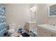 Bright bathroom featuring dual sinks with white cabinets and a shower with blue accents at 561 Holland Rd, Dallas, GA 30157