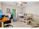 Cozy bedroom with a window view and a wooden bunkbed set, desk and swivel chair at 561 Holland Rd, Dallas, GA 30157