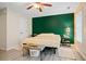 Bedroom with green accent wall, ceiling fan, neutral floors, and one window at 561 Holland Rd, Dallas, GA 30157