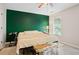 Inviting bedroom featuring a queen bed and a view of the backyard through a window at 561 Holland Rd, Dallas, GA 30157