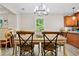 Dining room with wood floors, matching table and chairs next to the kitchen and a window view at 561 Holland Rd, Dallas, GA 30157