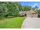 Lovely home with stone accents, manicured lawn, and a spacious driveway nestled among mature trees at 561 Holland Rd, Dallas, GA 30157