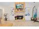 Cozy living room with a stone fireplace, built-in bookshelves, and wood-look flooring at 561 Holland Rd, Dallas, GA 30157