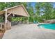 Outdoor pavilion with a built-in grill and bar area next to the pool, perfect for entertaining at 561 Holland Rd, Dallas, GA 30157