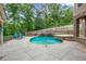 Outdoor view of the in-ground pool with backyard pavilion and lush landscaping at 561 Holland Rd, Dallas, GA 30157