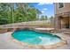 Relaxing in-ground pool with lush landscaping and stone accents create an outdoor retreat at 561 Holland Rd, Dallas, GA 30157