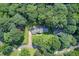 Aerial perspective of a home nestled within a dense, mature tree coverage at 2612 Spring St, Dacula, GA 30019