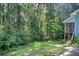 Lush backyard with mature trees and greenery creating a private and serene outdoor space at 2612 Spring St, Dacula, GA 30019