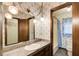 Bathroom offers unique vintage wallpaper, hanging lights, and sink vanity at 2612 Spring St, Dacula, GA 30019