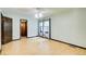 Open bedroom featuring two windows, hardwood floors, ceiling fan and doorway at 2612 Spring St, Dacula, GA 30019