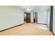 Large bedroom with hardwood flooring, ceiling fan, natural light, and multiple doorways at 2612 Spring St, Dacula, GA 30019