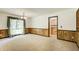 Bright dining room with decorative wall paneling and view into the kitchen at 2612 Spring St, Dacula, GA 30019
