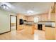 Bright eat-in kitchen with light wood cabinets, black appliances, and center island at 2612 Spring St, Dacula, GA 30019