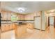 Eat-in kitchen features light wood cabinets, black appliances and center island at 2612 Spring St, Dacula, GA 30019