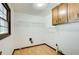 Convenient laundry room with overhead storage and window at 2612 Spring St, Dacula, GA 30019