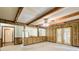 Spacious room with wood paneling, beam ceiling, and views to the front entryway at 2612 Spring St, Dacula, GA 30019